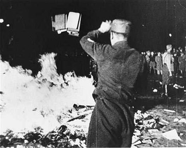 A member of the SA throws confiscated books into the bonfire during the public burning of “un-German” books on the Opernplatz in Berlin, May 10, 1933.